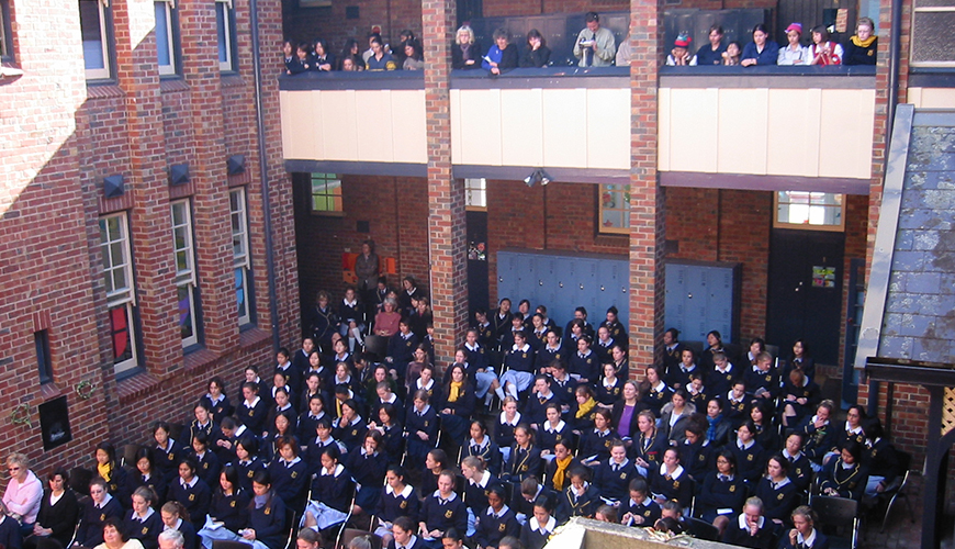 Students and invited guests watch Shakespeare Day in the Tourmont Courtyard in 2004